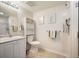 Clean bathroom featuring a shower, sink, toilet and light neutral colors throughout the room at 31819 Rocky Village Dr # 208, Evergreen, CO 80439