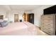 Bedroom featuring a large dresser and TV with a partial view of the en-suite bathroom at 31819 Rocky Village Dr # 208, Evergreen, CO 80439