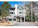 Attractive building facade with stone accents and lush greenery in a serene setting at 31819 Rocky Village Dr # 208, Evergreen, CO 80439