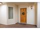 Entryway featuring a wooden front door with wreath detail, complementing the building's facade and inviting entrance at 31819 Rocky Village Dr # 208, Evergreen, CO 80439