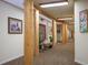 Hallway featuring southwest decor and wooden pillars, adding a rustic and artistic touch to the building's interior at 31819 Rocky Village Dr # 208, Evergreen, CO 80439