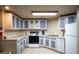 Functional kitchen featuring classic cabinets, white appliances, and ample counter space at 31819 Rocky Village Dr # 208, Evergreen, CO 80439