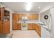 Efficient kitchen with oak cabinets, white countertops and appliances at 31819 Rocky Village Dr # 208, Evergreen, CO 80439