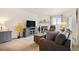 Well-lit living area featuring a fireplace, a flatscreen tv, and neutral tones at 31819 Rocky Village Dr # 208, Evergreen, CO 80439