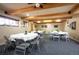 Bright meeting room with wood beam ceiling, round tables and seating for group activities at 31819 Rocky Village Dr # 208, Evergreen, CO 80439