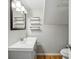 Cozy bathroom with single sink vanity, open shelving, and white fixtures at 1333 N Lafayette St, Denver, CO 80218