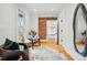 Bright bedroom shows a seating area with chairs, exposed brick and a walk-in closet at 1333 N Lafayette St, Denver, CO 80218