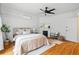 Inviting bedroom features hardwood floors, a ceiling fan and a decorative fireplace at 1333 N Lafayette St, Denver, CO 80218