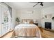 Relaxing bedroom features hardwood floors, a fireplace and French doors leading to a balcony at 1333 N Lafayette St, Denver, CO 80218