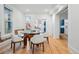 Elegant dining room with hardwood floors, wainscoting, and a modern glass table at 1333 N Lafayette St, Denver, CO 80218