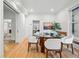Open dining room with hardwood floors, a glass table, and seamless transition to other rooms at 1333 N Lafayette St, Denver, CO 80218