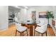 Dining room showcasing a glass-top table, hardwood floors, and views into other rooms at 1333 N Lafayette St, Denver, CO 80218