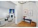 Bright entryway with hardwood floors, a bench seat, and decor leading to living room with fireplace at 1333 N Lafayette St, Denver, CO 80218