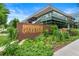 Exterior view of Denver Botanic Gardens with lush greenery, showcasing the entrance sign and modern architecture at 1333 N Lafayette St, Denver, CO 80218