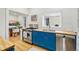 Kitchen with stainless steel appliances, blue cabinets, butcher block countertops and view of the dining area at 1333 N Lafayette St, Denver, CO 80218