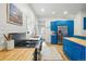 Contemporary kitchen with stainless steel appliances, wood counters, and sleek blue cabinetry at 1333 N Lafayette St, Denver, CO 80218