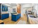 Modern kitchen with butcher block countertops, blue cabinetry, and exposed brick at 1333 N Lafayette St, Denver, CO 80218