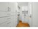 Bright laundry room with custom cabinets, sink, and stainless steel beverage fridge at 1333 N Lafayette St, Denver, CO 80218