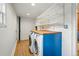 Laundry room with side-by-side washer and dryer under a wood countertop at 1333 N Lafayette St, Denver, CO 80218