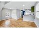 Open floor plan with hardwood floors and natural light leads to a small kitchen at 1333 N Lafayette St, Denver, CO 80218