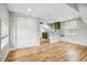 Living space with hardwood floors leads to kitchen area featuring modern appliances and shelving at 1333 N Lafayette St, Denver, CO 80218