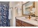 Charming bathroom featuring floral shower curtain and ornate mirror at 494 Owl Dr # 4, Louisville, CO 80027