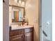 Cozy bathroom with traditional vanity, decorative mirror, and ample lighting at 494 Owl Dr # 4, Louisville, CO 80027