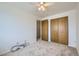 Bright bedroom featuring neutral carpet, ceiling fan and spacious closets at 494 Owl Dr # 4, Louisville, CO 80027