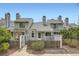 Charming townhome featuring a fenced front yard and unique architectural details at 494 Owl Dr # 4, Louisville, CO 80027