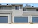 Exterior of a townhome with a garage and light gray siding, offering a clean and modern look at 494 Owl Dr # 4, Louisville, CO 80027