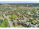 This aerial shows a home located in a suburban neighborhood with mature trees and manicured lawns at 7132 S Tempe Ct, Aurora, CO 80016