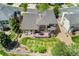 Aerial view showcasing the home's backyard with lush greenery, a deck, and a well-manicured garden at 7132 S Tempe Ct, Aurora, CO 80016