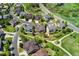 An aerial view shows this home nestled in a desirable community with mature trees and green spaces at 7132 S Tempe Ct, Aurora, CO 80016