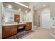 Spacious bathroom with double sinks, vanity, shower, and tile flooring, next to the main bedroom at 7132 S Tempe Ct, Aurora, CO 80016