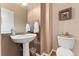 Neat bathroom with pedestal sink and modern fixtures at 7132 S Tempe Ct, Aurora, CO 80016