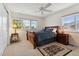 Bright bedroom with a wooden sleigh bed, bedside tables, and a patterned rug, creating a serene and relaxing space at 7132 S Tempe Ct, Aurora, CO 80016