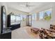 Bedroom featuring large windows, ceiling fan, and sitting area at 7132 S Tempe Ct, Aurora, CO 80016
