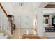Bright and spacious foyer with high ceilings, a staircase, and marble flooring at 7132 S Tempe Ct, Aurora, CO 80016