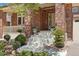 Charming front porch with brick columns, stairs, and decorative potted plants at 7132 S Tempe Ct, Aurora, CO 80016