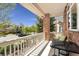 Inviting covered front porch with table, chairs, and views of the neighborhood at 7132 S Tempe Ct, Aurora, CO 80016