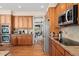 Kitchen area features stainless steel appliances, wood cabinets, and stone countertops at 7132 S Tempe Ct, Aurora, CO 80016