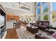 Spacious living room open to kitchen and dining area, featuring large windows and modern finishes at 7132 S Tempe Ct, Aurora, CO 80016
