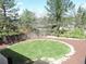Serene backyard with well-maintained lawn, landscaping, and a privacy fence. Storage shed in view at 7753 W Plymouth S Pl, Littleton, CO 80128