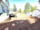 Expansive backyard with a deck, two storage sheds, mulch ground cover, and a stone path at 7753 W Plymouth S Pl, Littleton, CO 80128