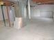 Unfinished basement featuring utilities and concrete flooring, providing a blank canvas for customization at 7753 W Plymouth S Pl, Littleton, CO 80128