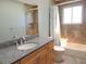 Bathroom featuring a single sink vanity with granite counters and a shower-tub combination at 7753 W Plymouth S Pl, Littleton, CO 80128