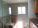 Bright bathroom featuring a granite vanity, tub-shower combo with a glass partition and tiled walls at 7753 W Plymouth S Pl, Littleton, CO 80128