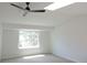 Bright bedroom with natural light from skylight and large window, enhanced by ceiling fan at 7753 W Plymouth S Pl, Littleton, CO 80128