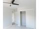 This bedroom has a ceiling fan, closet with sliding doors, and new tile flooring at 7753 W Plymouth S Pl, Littleton, CO 80128