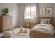 Bright and airy bedroom featuring a wooden bed frame, soft neutral colors, and a calming atmosphere at 7753 W Plymouth S Pl, Littleton, CO 80128